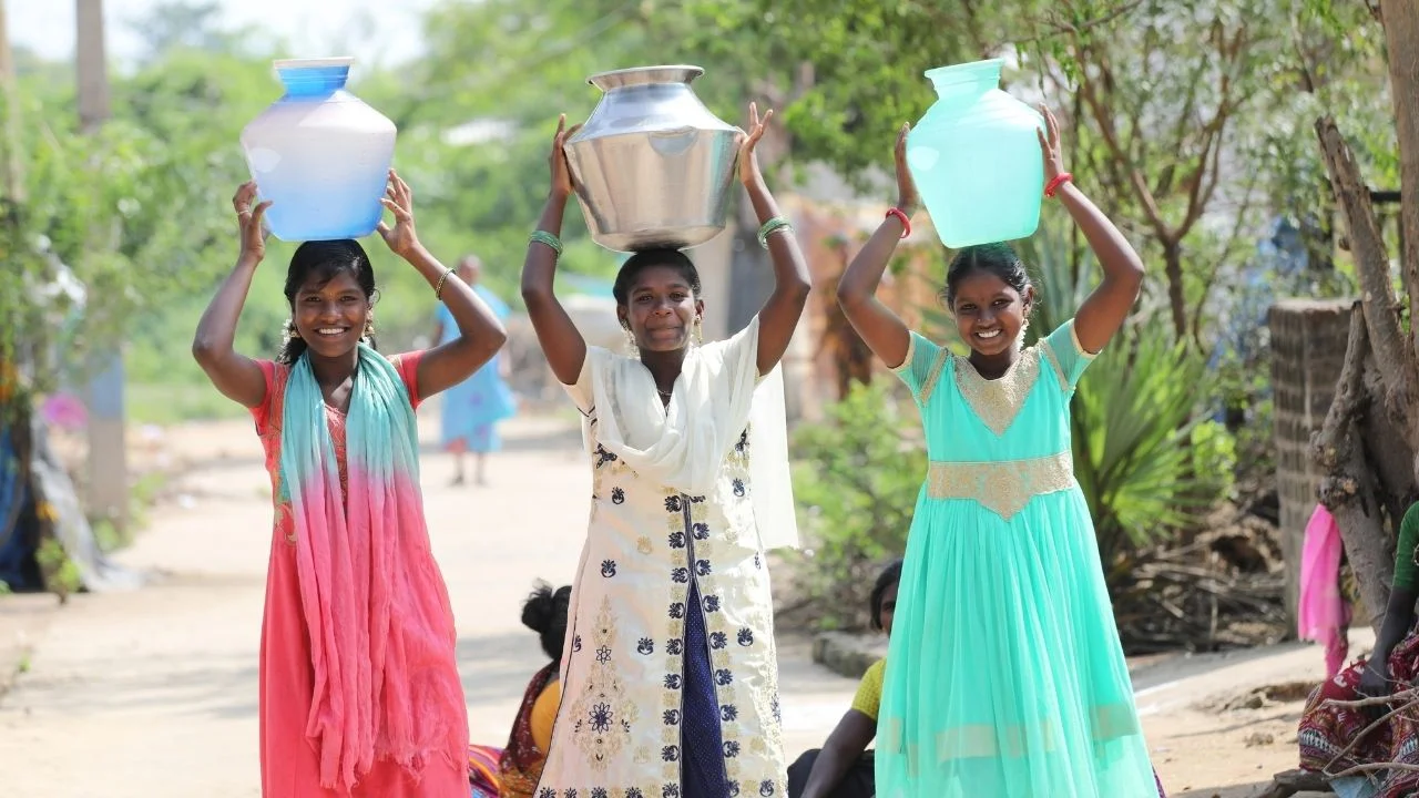 Girls in India carrying water